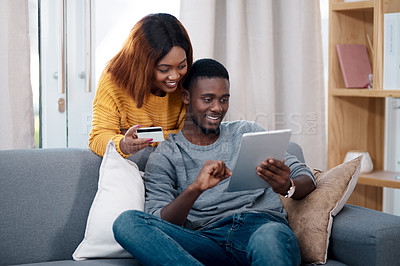 Buy stock photo Tablet, credit card and a black couple online shopping on a sofa in the living room of their home together. Ecommerce, bank or payment with a man and woman customer in a house to shop on the internet