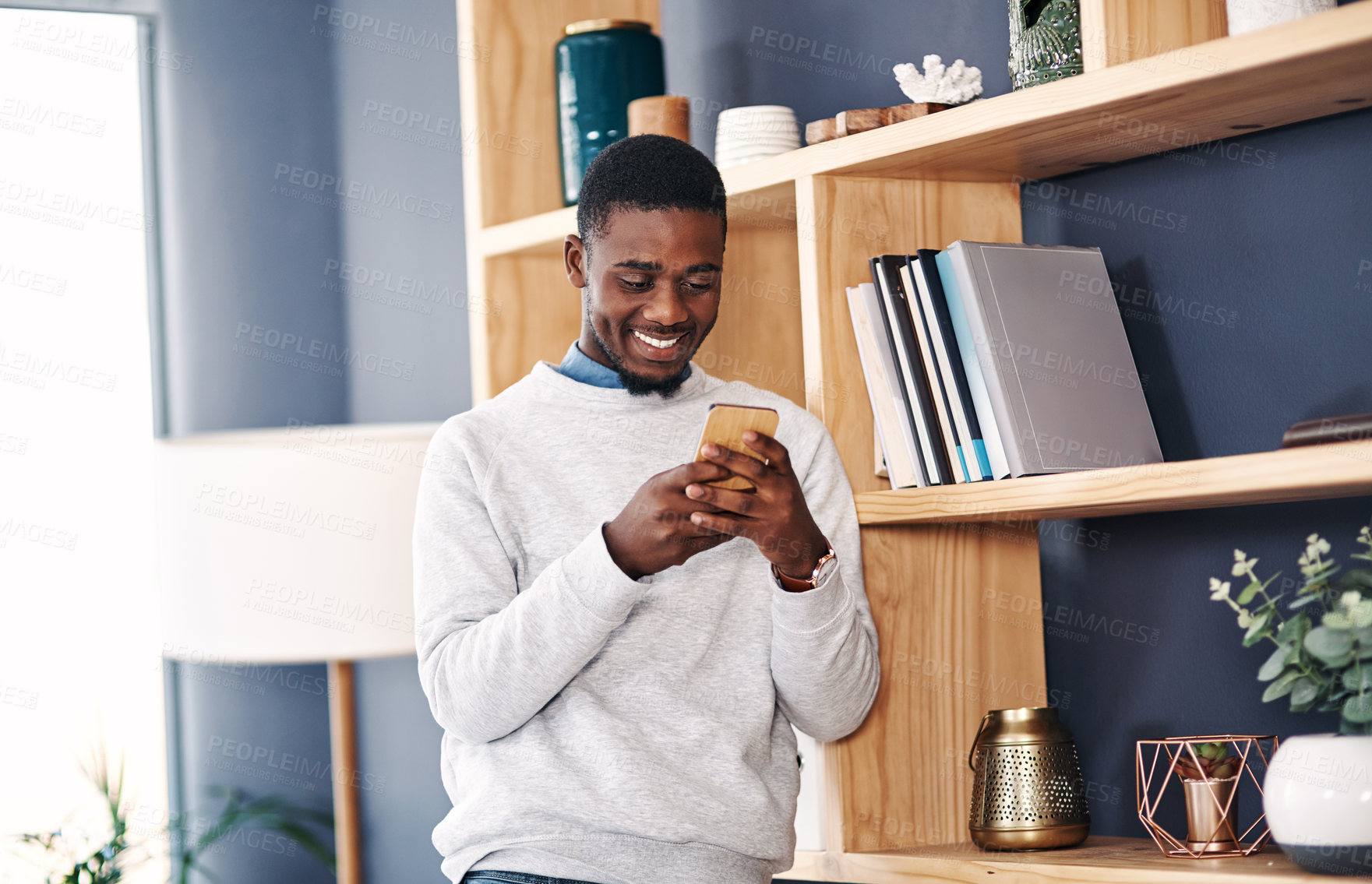 Buy stock photo Smartphone, tech and black man in office for social media, network or check email. Creative worker, professional and male person with cellphone or online for internet, website or mobile app.