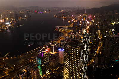 Buy stock photo Aerial, skyscrapers and night city of office buildings with lake, lights and riverside in the outdoors. Drone view of CBD, architecture or cityscape and late infrastructure lighting of a urban town
