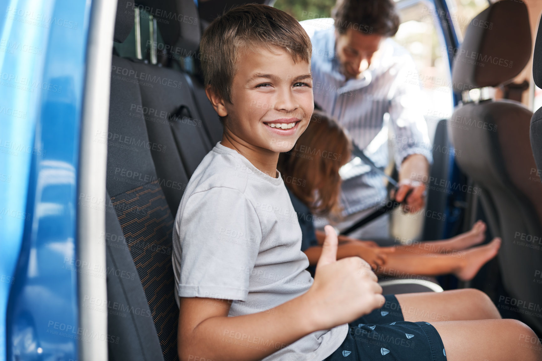 Buy stock photo Cropped portrait of a young boy sitting in the car and showing a thumbs up before roadtripping with his family