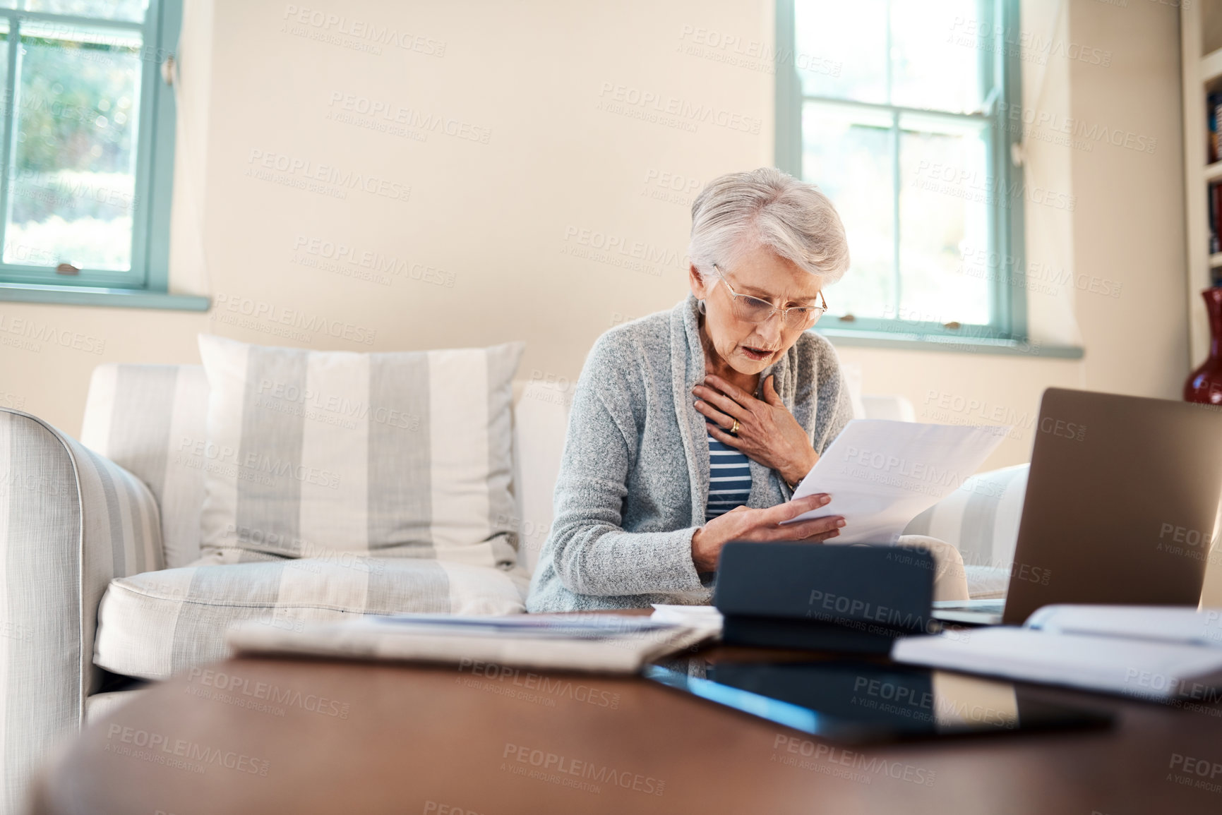 Buy stock photo Old woman, shock and stress for paperwork in home, finance and laptop mistake for payment. Female person, panic attack and reading documents with mortgage debt or loan expenses, taxes and anxiety