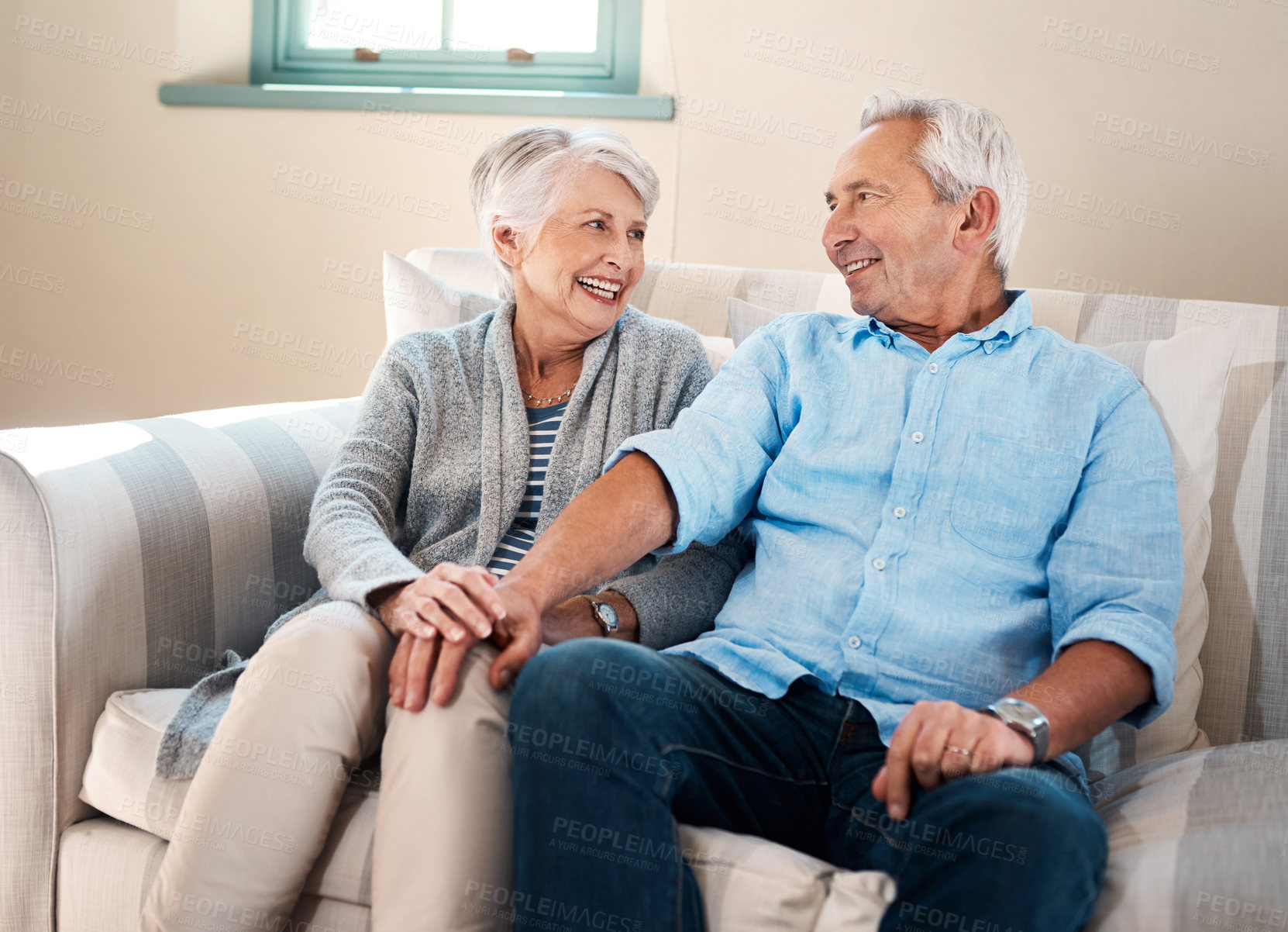 Buy stock photo Happy, holding hands and senior couple on sofa for connection, bonding and relaxing together at home. Smile, love and elderly man and woman in retirement laughing and resting in living room at house.