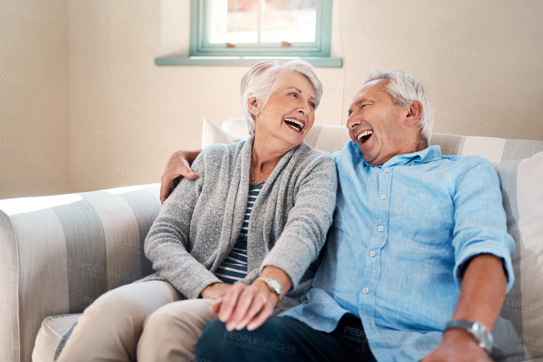 Buy stock photo Happy, laughing and senior couple on sofa for connection, bonding and relax together at home. Smile, love and elderly man and woman in retirement hugging, talking and resting in living room at house.