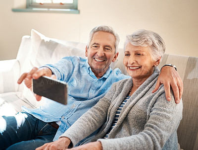 Buy stock photo Senior couple, selfie and happy on couch in retirement for social media, blog or post on internet. Elderly man, woman and photography for profile picture on app, web or smile together on lounge sofa