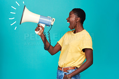 Buy stock photo Studio shot of a young woman using a megaphone against a turquoise background