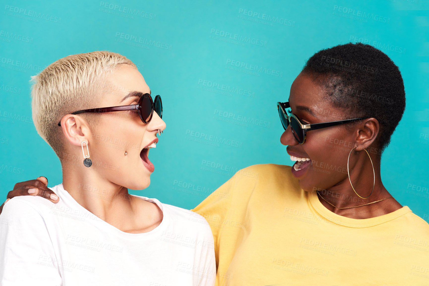 Buy stock photo Women, wow and sunglasses with surprise, together and bonding on blue background as friends. Female people, shock and smile as cheerful in diversity, conversation and communication on studio backdrop