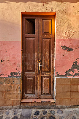 Buy stock photo Old damaged wooden door of an abandoned weathered building. Vintage broken and aged entrance to a house in a small village or down on a sunny day. Antique and rustic doorway of vacant home