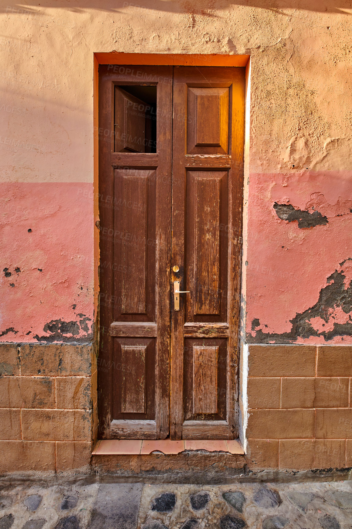 Buy stock photo Old damaged wooden door of an abandoned weathered building. Vintage broken and aged entrance to a house in a small village or down on a sunny day. Antique and rustic doorway of vacant home