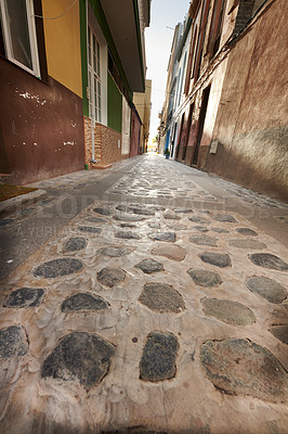 Buy stock photo Stone alleyway road with scenic view of dark residential buildings, old historic houses with traditional infrastructure. Tourism abroad, overseas travel destination in Santa Cruz, La Palma, Spain