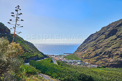 Buy stock photo Scenic view of banana plantations around Los Llanos, La Palma in Spain. Beautiful farmland on the countryside against a blue sky and ocean. Green mountains surrounding a deserted farming town
