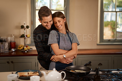 Buy stock photo Happy couple, hug and embrace with love in kitchen for cooking, breakfast or romantic morning at home. Young man and woman with smile for comfort, food or meal preparation in bonding or care at house