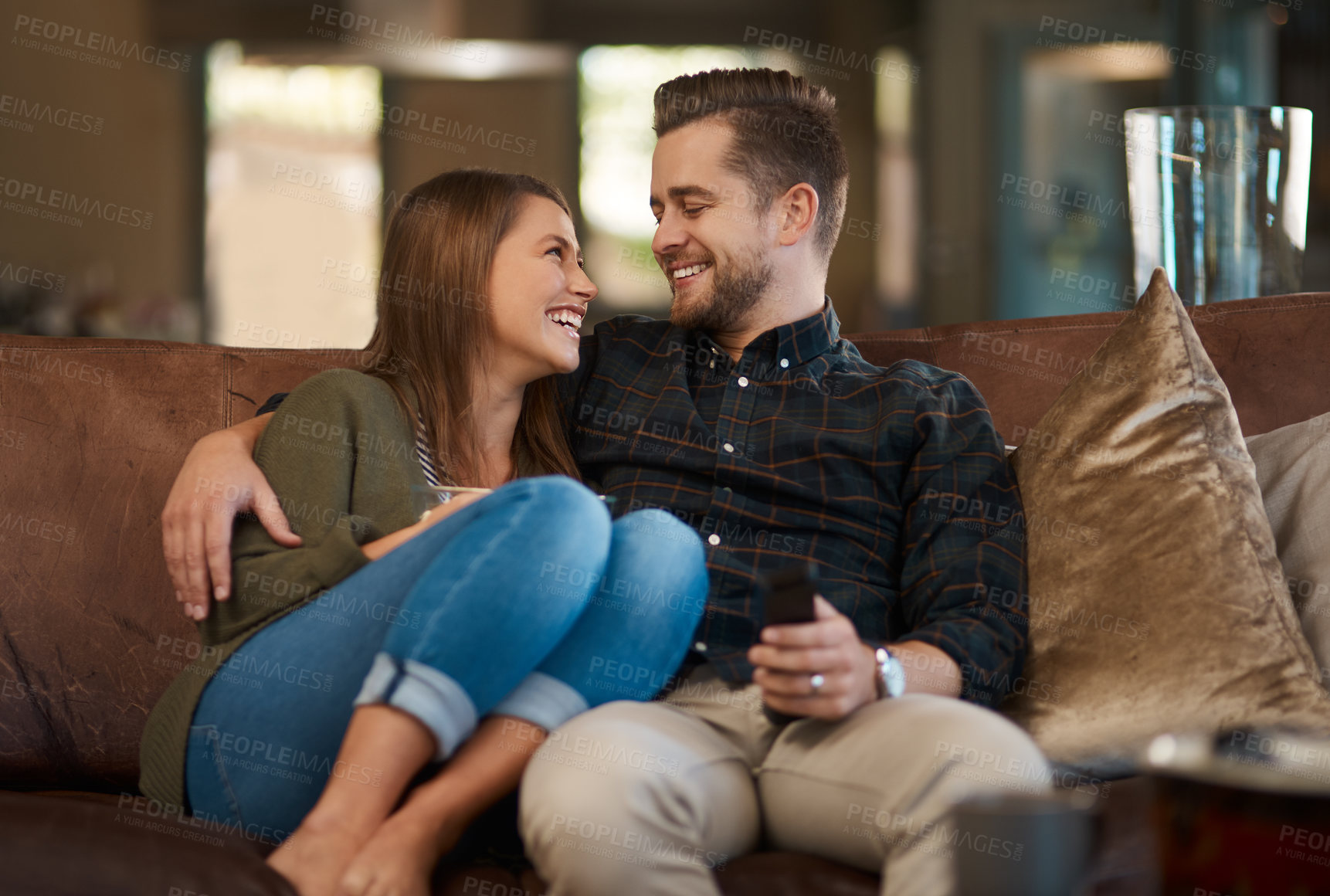 Buy stock photo Happy couple, smile and hug on sofa for support, care and in love for relationship and dating on weekend in home. Man, woman and cheerful in house for bond, affection or loving for vacation or unwind