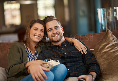 Buy stock photo Portrait, house and couple with popcorn, relax and happiness with love, break and entertainment in lounge. Face, home and man with woman, series or streaming movie with snack, smile and watching tv