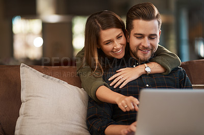 Buy stock photo Relax, laptop and social media with a couple on a sofa in the living room of their home together. Computer, web or internet with a man and woman hugging while bonding in their house on the weekend