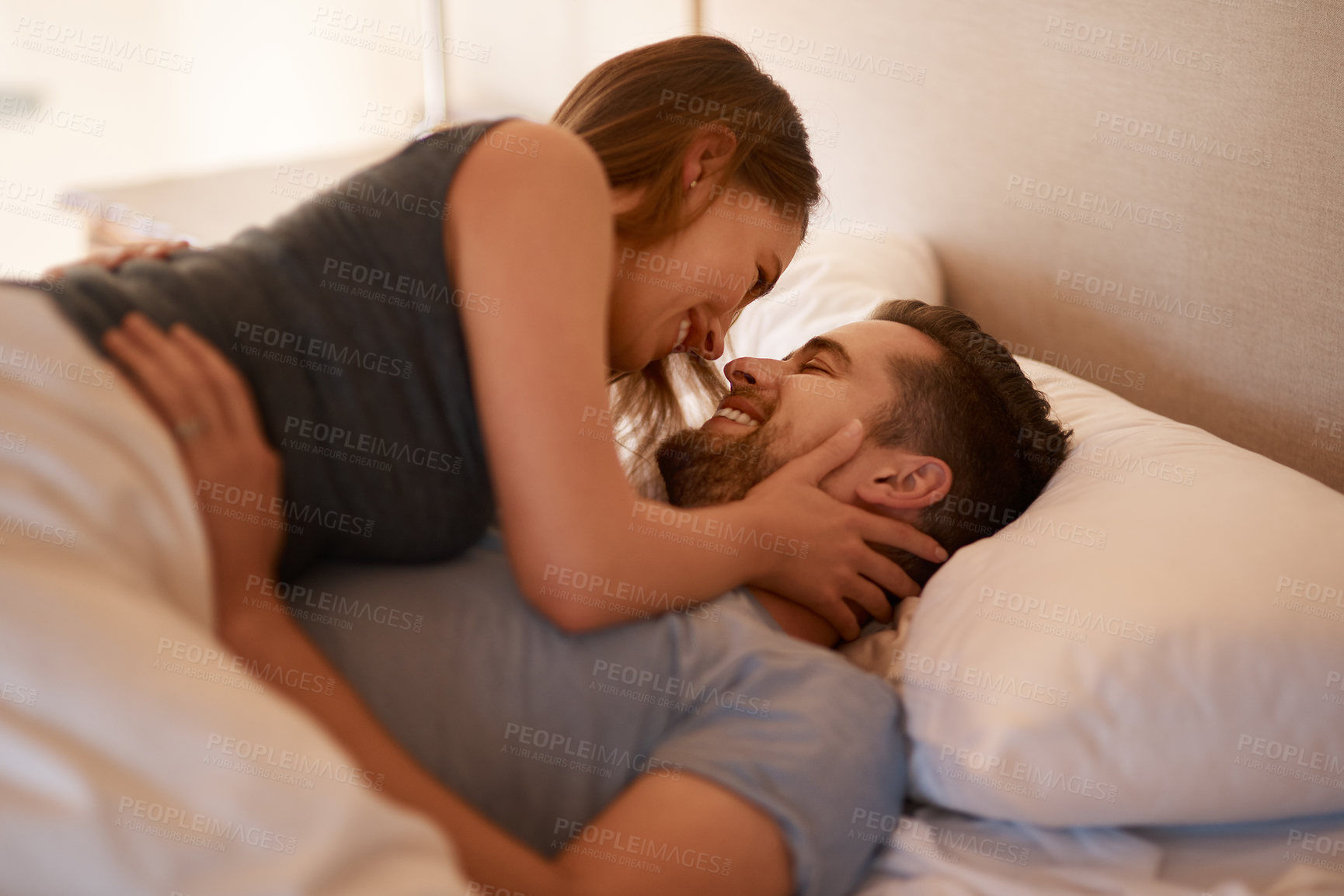 Buy stock photo Happy, love or couple in bed with desire, romance or intimacy, connection or bonding at home. Eye contact, foreplay or passion, attraction or trust in bedroom for anniversary or honeymoon celebration