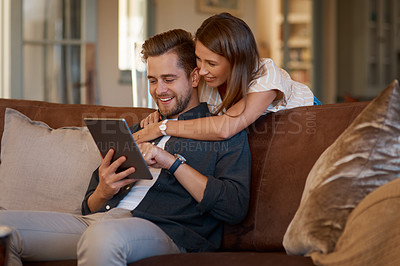 Buy stock photo Happy, sofa and couple on tablet for social media meme, internet joke and watching videos. Home, living room and man and woman on digital tech for website, connection and online chat on weekend