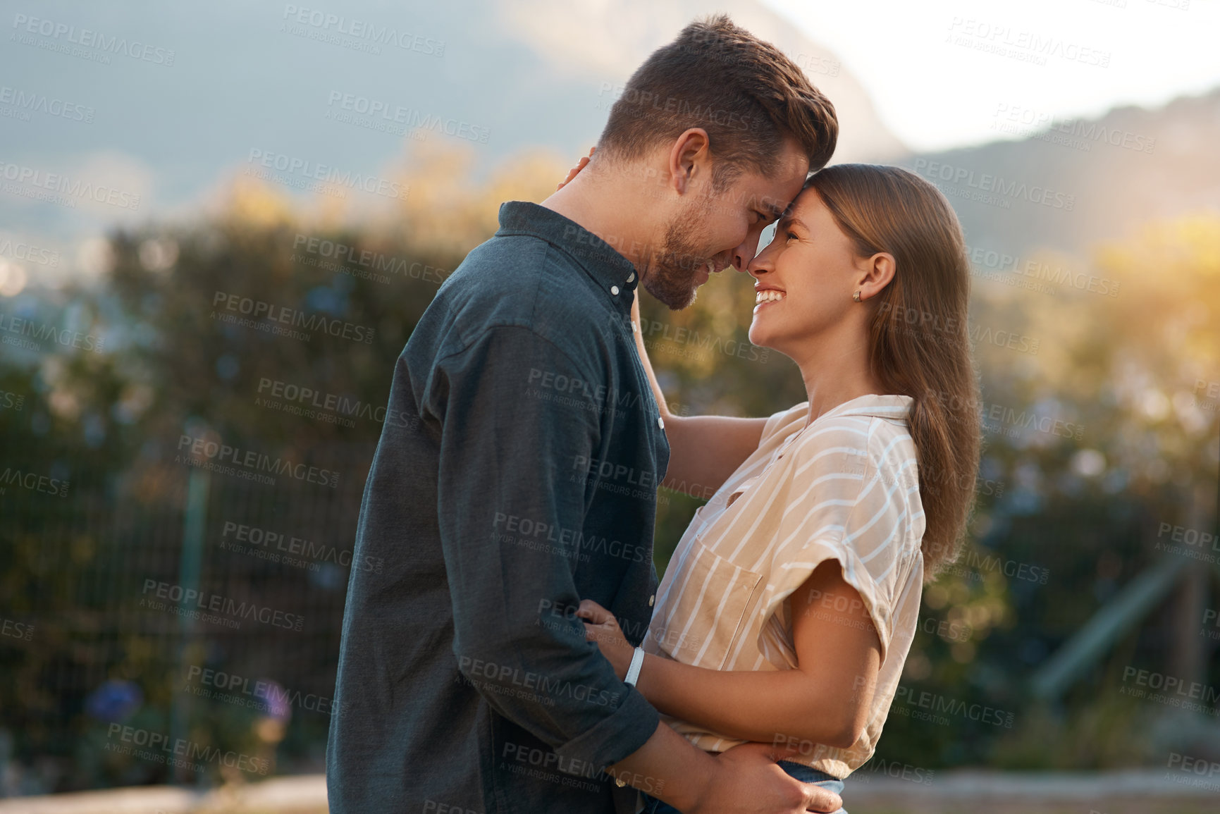 Buy stock photo Shot of an affectionate couple spending the day outdoors