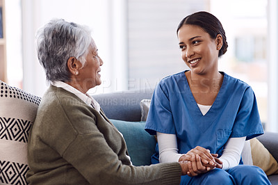 Buy stock photo Shot of a young nurse chatting to a senior woman in a retirement home