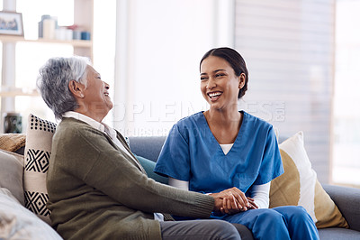 Buy stock photo Consulting, caregiver and elderly woman laughing on sofa and holding hands in home living room. Support or healthcare, happy and female nurse talking or communication with senior citizen on a couch