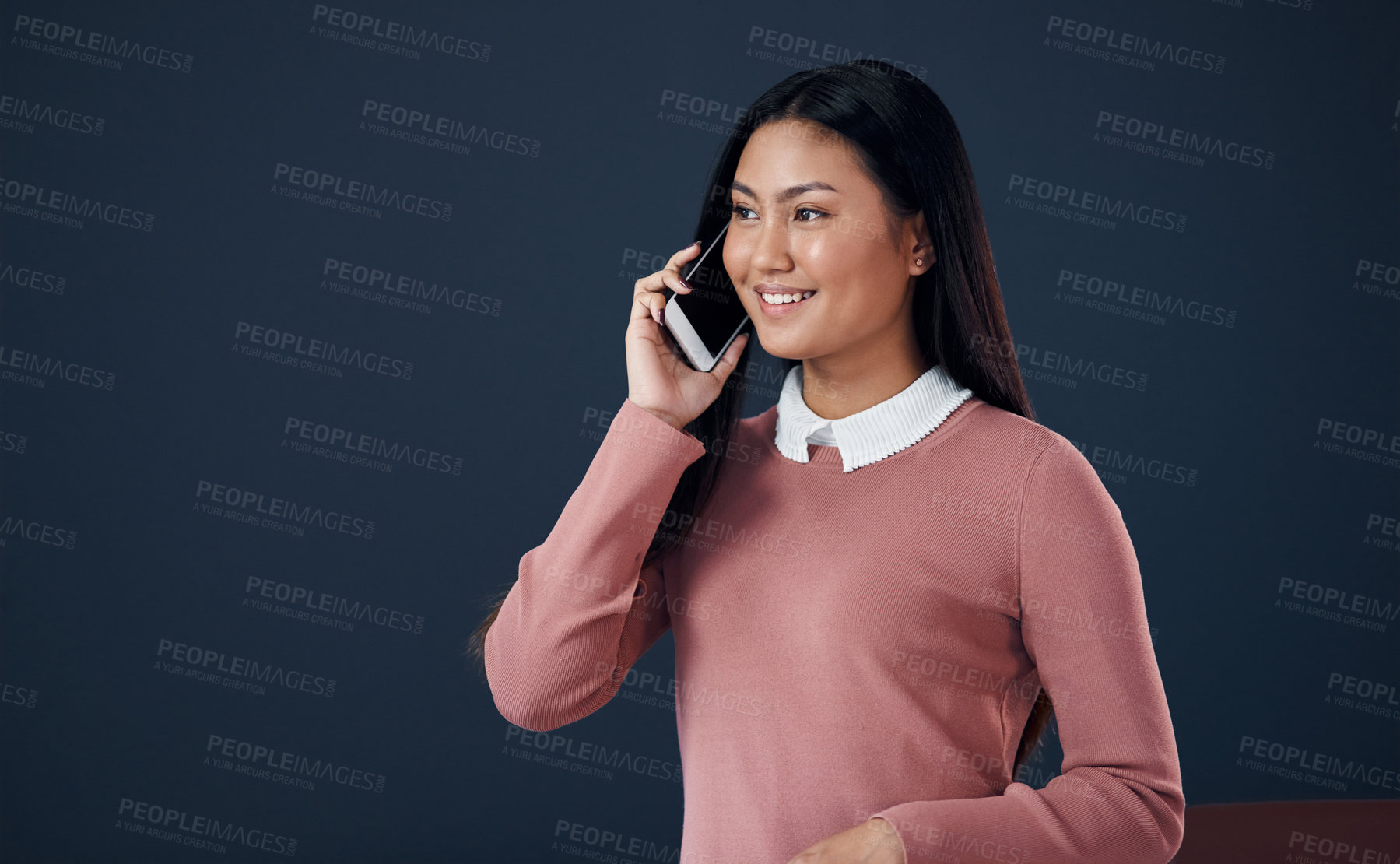 Buy stock photo Asian woman, discussion and communication with phone call for chat or talk on a dark studio background. Happy female person or young employee with smile and speaking on mobile smartphone or mockup