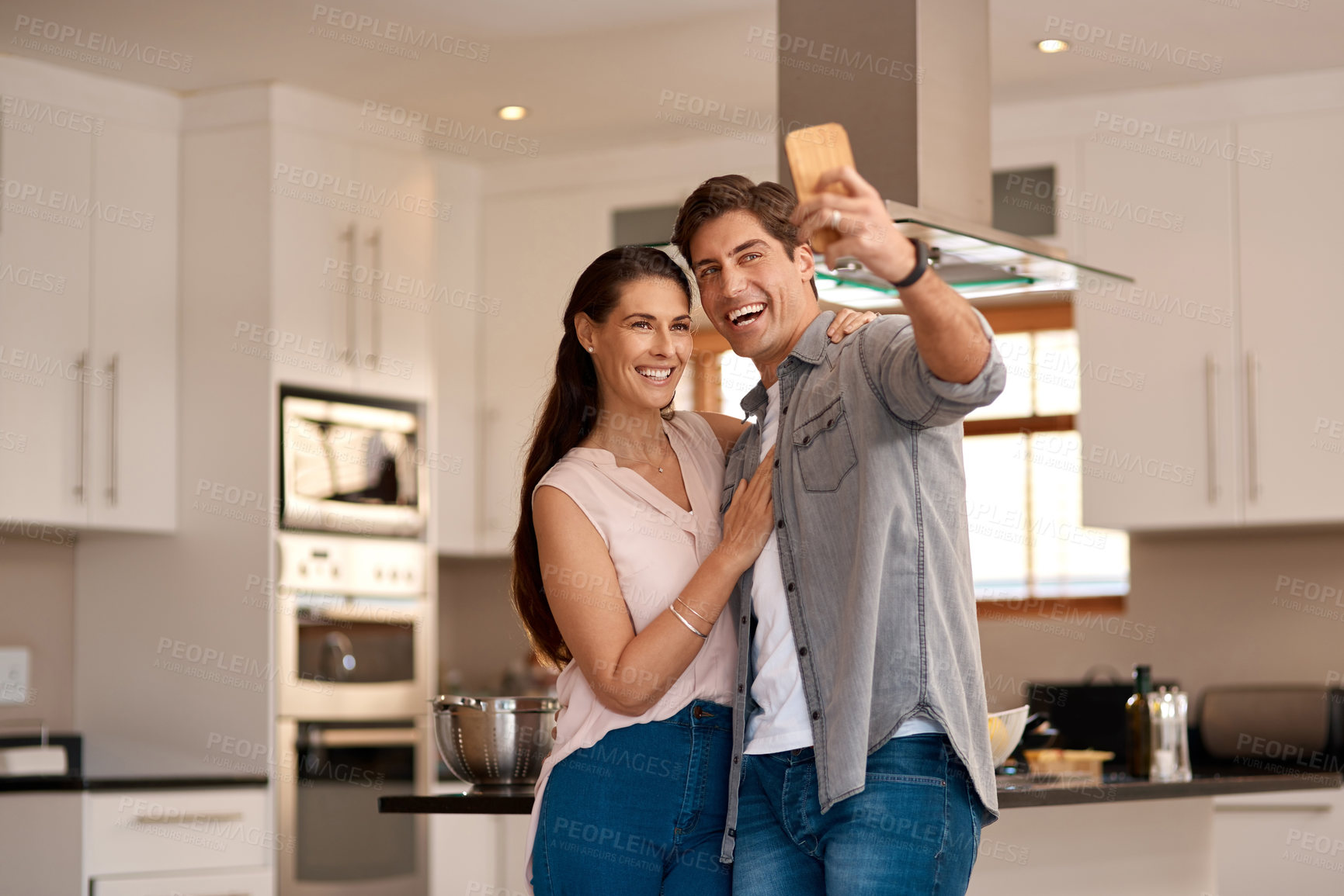Buy stock photo Couple hug, kitchen and selfie with smile for profile picture together, social media post and digital gallery. Home, woman and man for photo on mobile with embrace for happy memory, relax and love