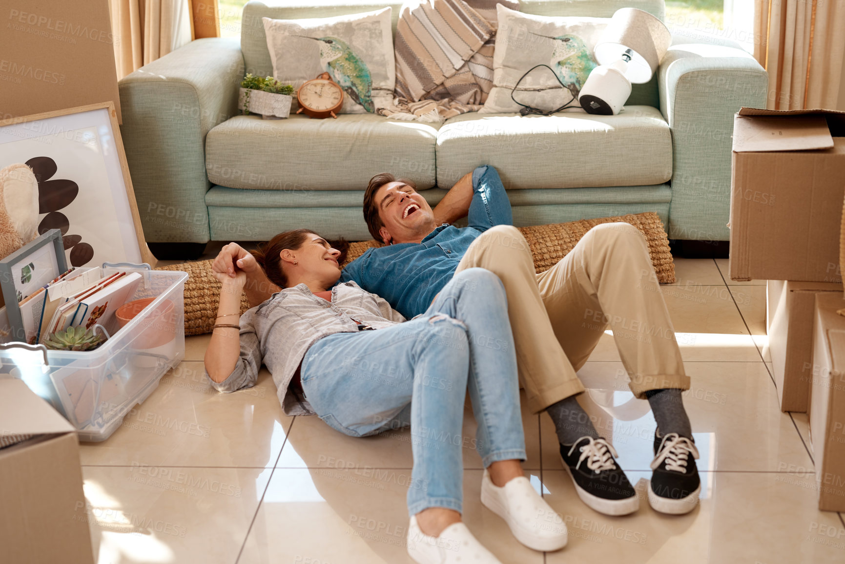 Buy stock photo Moving, home and couple relax on floor in living room tired with boxes in new house and property. Happy, people and lying on ground in apartment with excited in real estate, investment and marriage