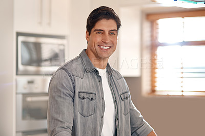 Buy stock photo Cropped portrait of a handsome young man standing in his kitchen at home
