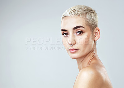 Buy stock photo Studio portrait of a beautiful young woman posing against a grey background
