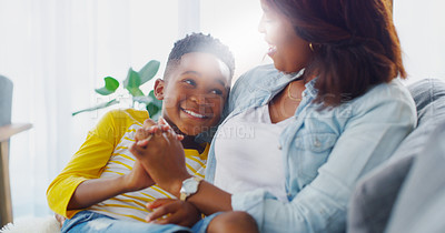 Buy stock photo Shot of an adorable little boy bonding and spending time with his mother at home