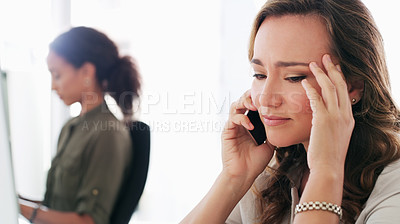 Buy stock photo Shot of a young businesswoman using a smartphone and looking stressed in a modern office