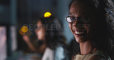 Buy stock photo Cropped portrait of an attractive young female call center agent working late in the office with her colleagues in the background