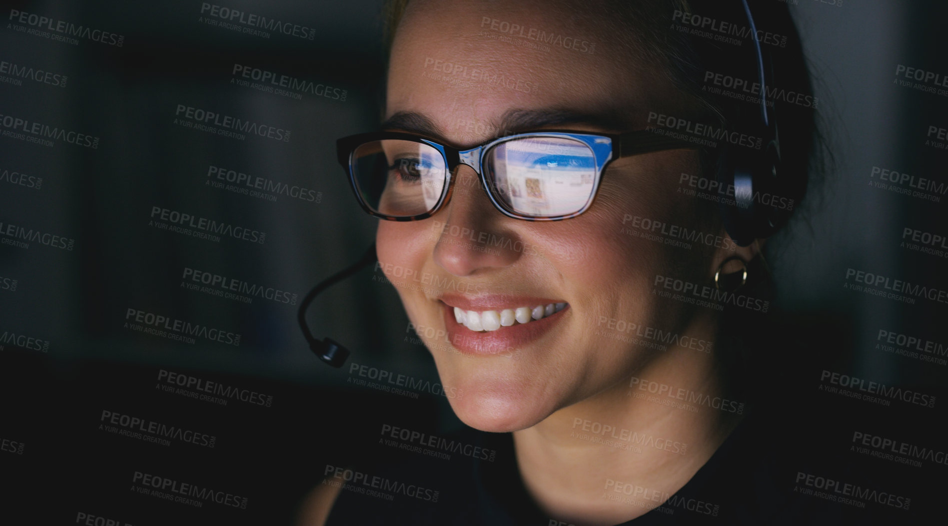Buy stock photo Cropped shot of an attractive young female call center agent working late at night in the office