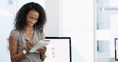 Buy stock photo Shot of a confident young businesswoman writing in a notebook in a modern office