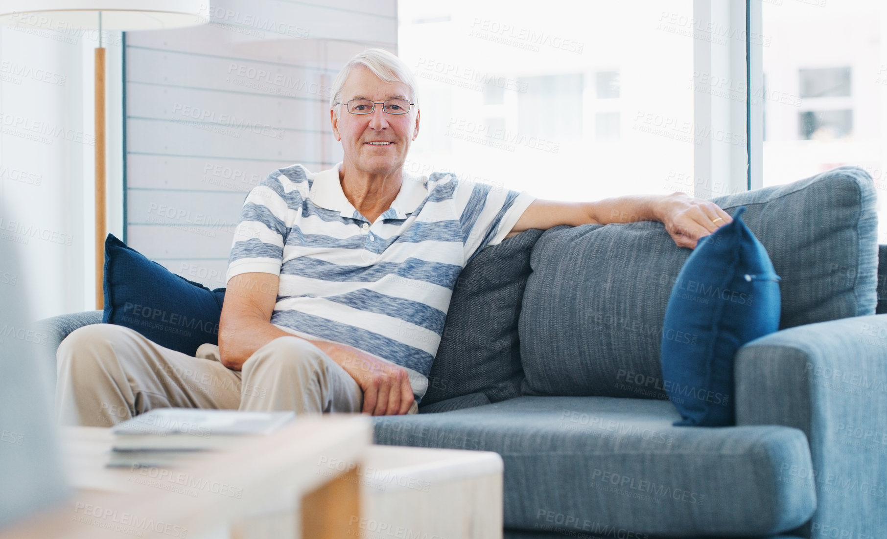 Buy stock photo Shot of a senior man relaxing on the sofa at home