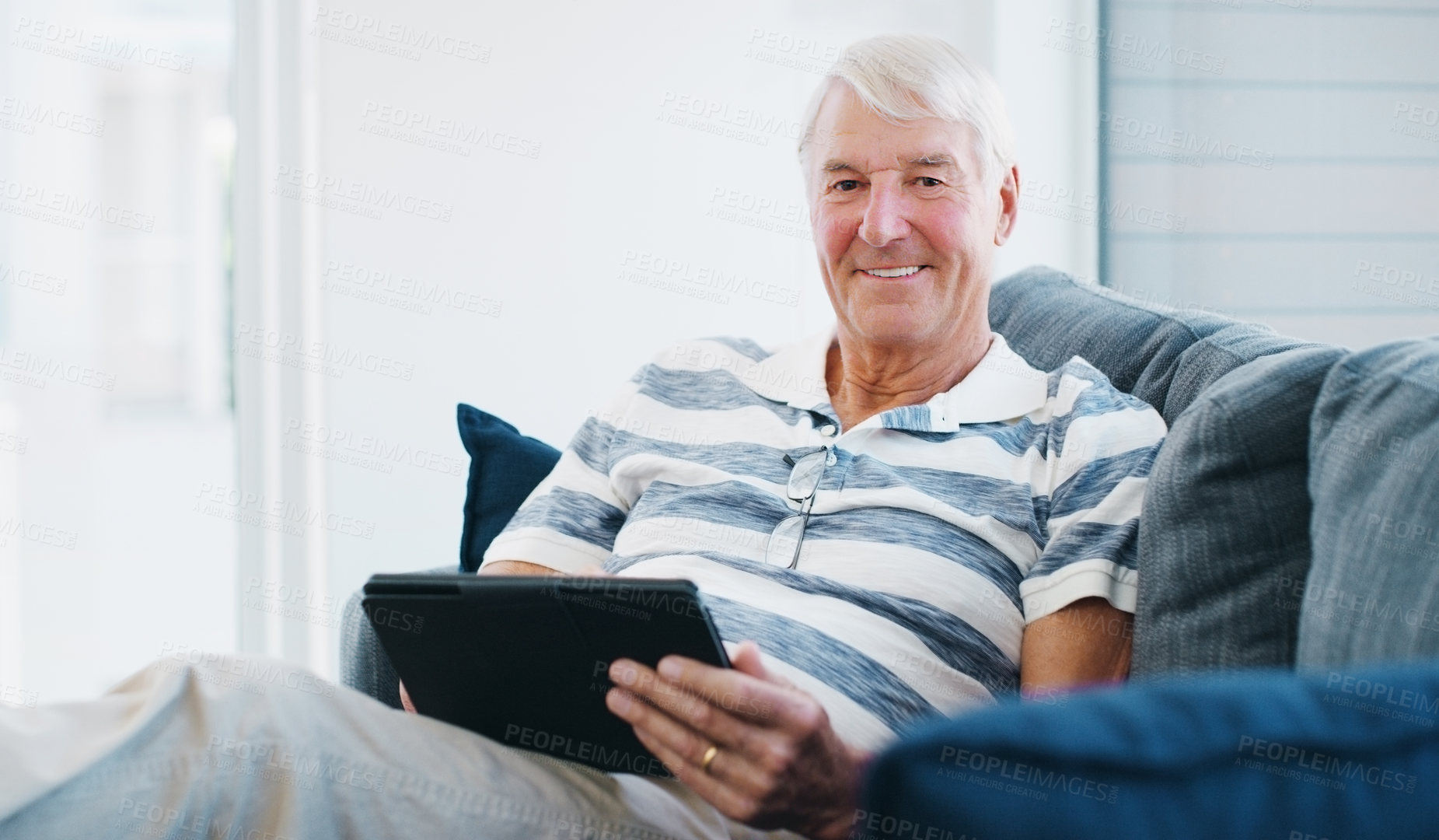 Buy stock photo Senior man, tablet and portrait in home with digital news or web puzzle app with game on sofa. Online, tech and living room with internet scroll and search for social media setup advice with smile