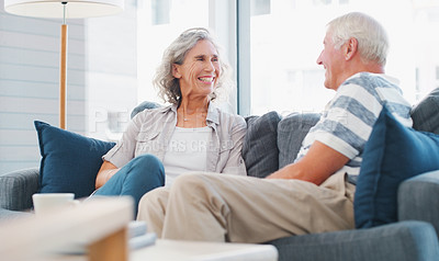 Buy stock photo Mature couple, home and smile on sofa in living room on break, bonding and relax. People, relationship and laughing for happy with gossip for conversation, chat and funny memories on couch with care