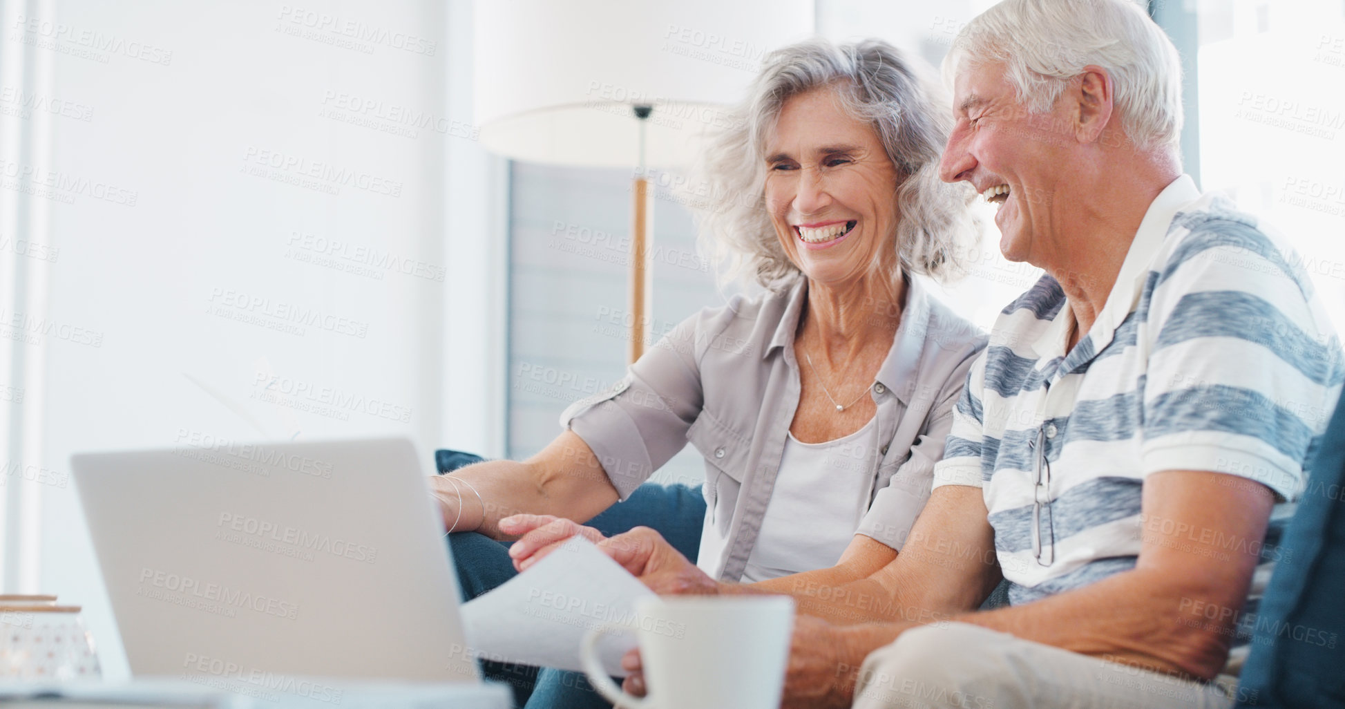 Buy stock photo Shot of a senior couple going through paperwork on the sofa at home