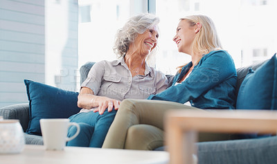 Buy stock photo Shot of a young woman spending quality time with her mother at home