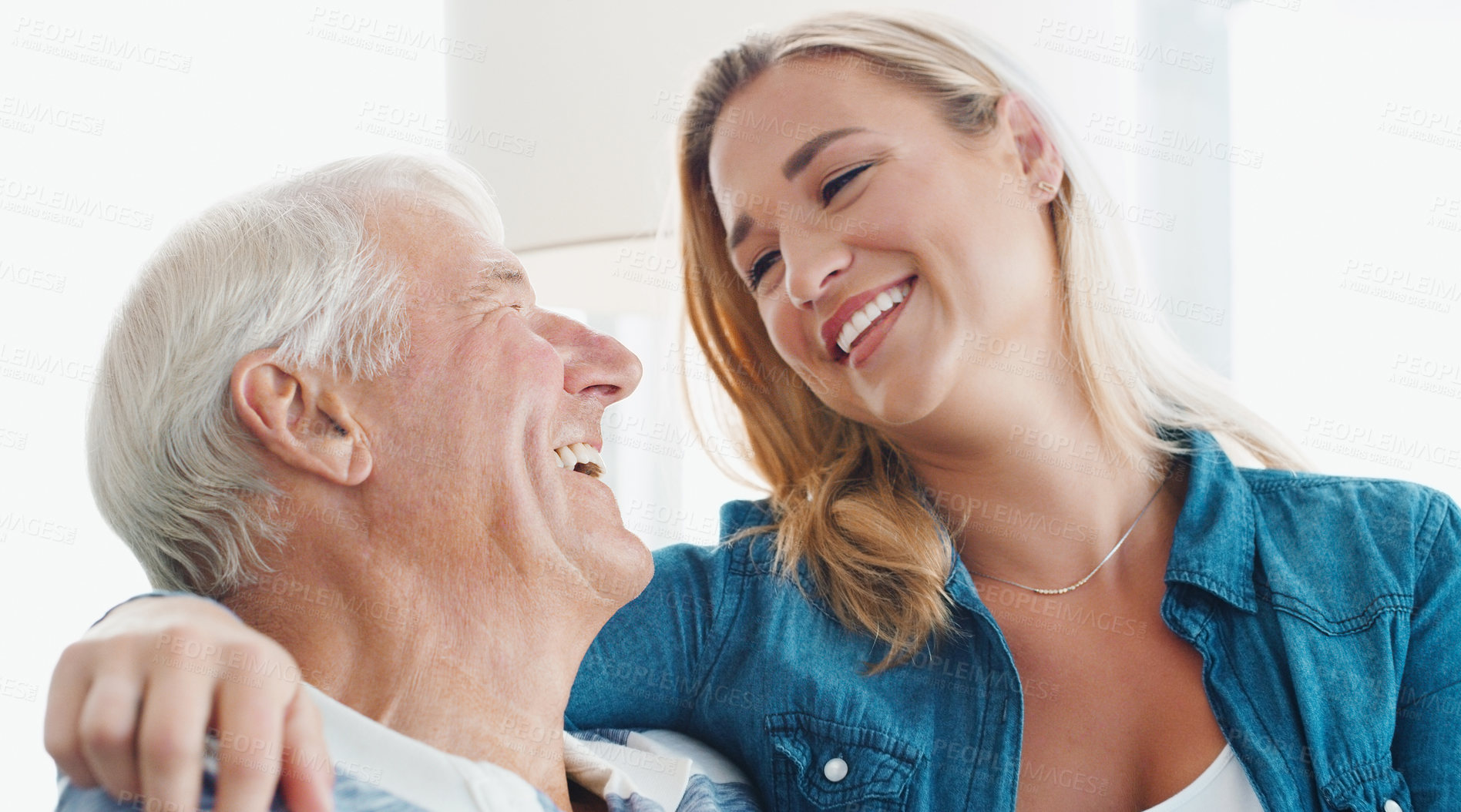 Buy stock photo Shot of a young woman spending quality time with her father at home