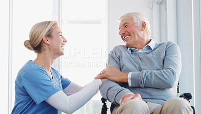 Buy stock photo Shot of a senior man in a wheelchair being cared for by a young nurse