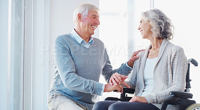 Buy stock photo Shot of a senior woman in a wheelchair being cared for by her husband