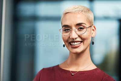 Buy stock photo Cropped portrait of an attractive young businesswoman wearing spectacles and standing alone in her office