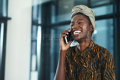 Buy stock photo Cropped shot of an attractive young businesswoman standing alone in her office and laughing while talking on her cellphone