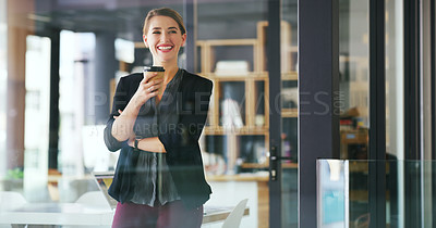 Buy stock photo Cropped shot of an attractive young businesswoman standing alone in her office and holding a cup of coffee