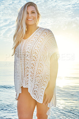 Buy stock photo Shot of a beautiful woman spending time at the beach on a sunny day