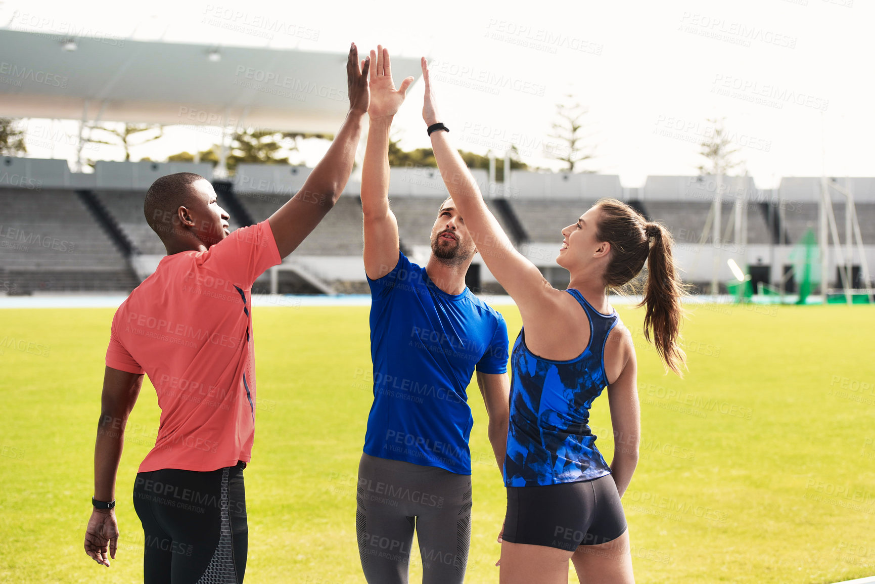 Buy stock photo Diversity, team and high five on stadium for running, exercise or training together in athletics. Group touching hands in celebration, unity or solidarity for exercising, run or winning in fitness