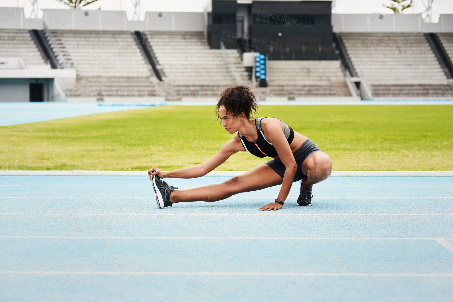 Buy stock photo Woman, fitness and stretching body on stadium track for running, exercise or workout. Active female person or athlete in warm up leg stretch for sports training, athletics or cardio run outdoors