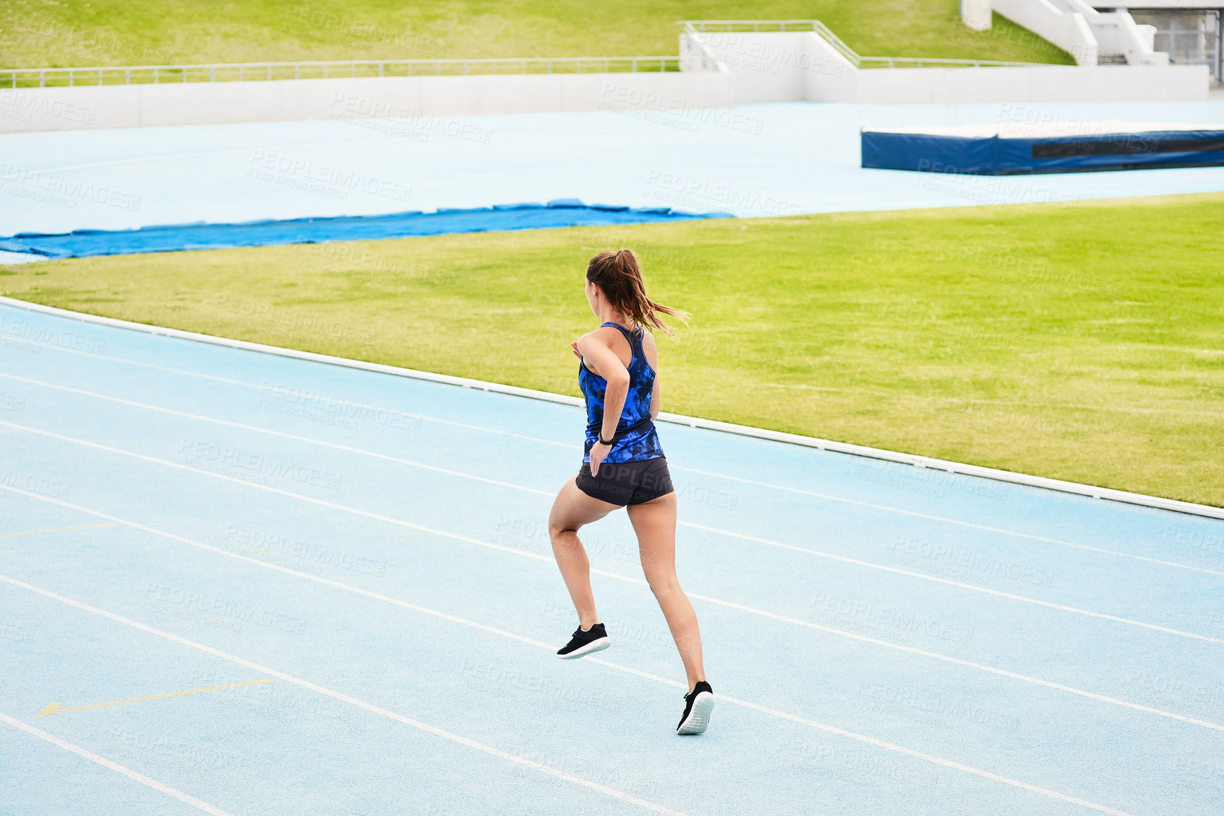 Buy stock photo Woman, back and running on stadium track in fitness, exercise or workout for cardio training outdoors. Fit, active or sporty female person, runner or athlete sprinting competition, exercising or race