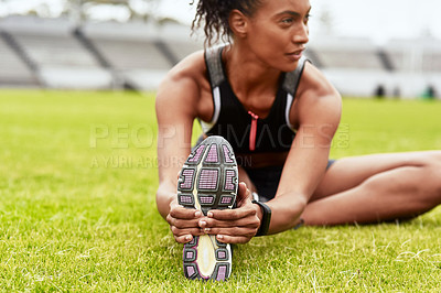 Buy stock photo Woman, athlete and stretching legs on grass at stadium in preparation for running, exercise or workout. Active or fit female person in warm up leg stretch for fitness, sports or run on the field