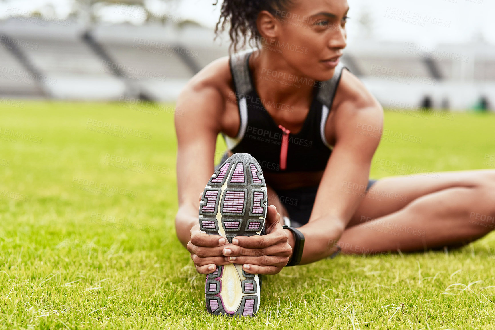 Buy stock photo Woman, athlete and stretching legs on grass at stadium in preparation for running, exercise or workout. Active or fit female person in warm up leg stretch for fitness, sports or run on the field